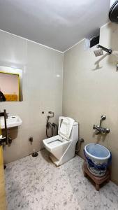 a bathroom with a toilet and a sink at The Ortus Stays -The Sunset Room in Orchha