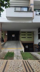 a building with two garage doors and a balcony at Infante Loft 402P - WAIWA HOST in Bucaramanga