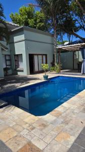 a swimming pool in front of a house at Moments and Memories house in East London