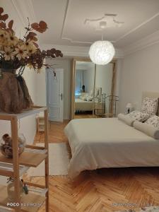 a bedroom with a bed and a living room at Casa Angela in Santoña