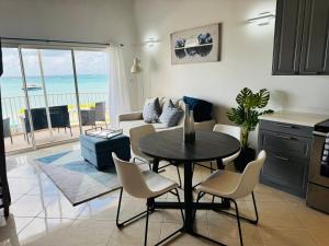 a kitchen and living room with a table and chairs at Beachfront Condo on Boardwalk in Philipsburg