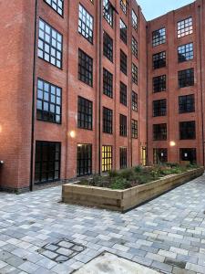 a brick building with a courtyard in front of it at Luxury City Centre Loft in Birmingham