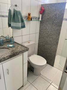 a small bathroom with a toilet and a shower at Casa Aconchego Formosa em Praia de Formosa Cabedelo Paraíba in Cabedelo +7 photos
