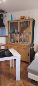 a living room with a book shelf and a table at Chez Madeleine in Jaignes