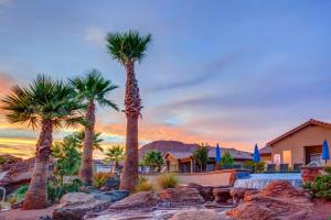 a group of palm trees in front of a house at Red Mountain Paradise: Paradise Village #90 in Santa Clara