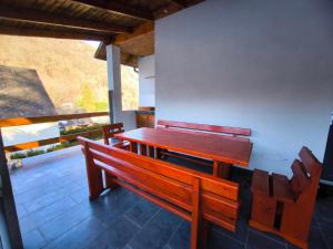 a wooden bench sitting on top of a patio at Forest Residence Miskolc in Miskolc