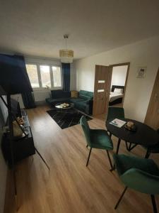 a living room with a couch and a table and chairs at Apartmán Miriam in Nitra
