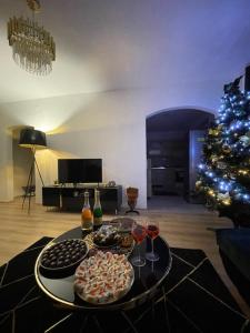 a living room with a christmas tree and a table with gifts at Apartmán Miriam in Nitra