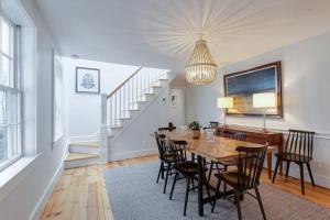 a dining room with a table and chairs and a staircase at The Tidewater in Alexandria