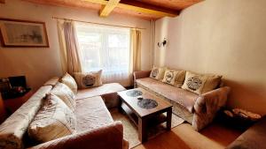 a living room with a couch and a table at Apartmány Anička vo Važci in Važec
