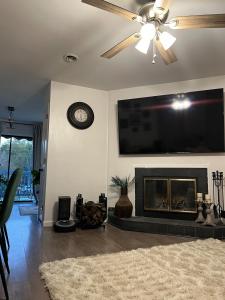 a living room with a fireplace and a flat screen tv at Lovely 2BR Condo near UNCW Beach in Wilmington