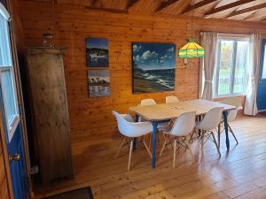 a dining room with a table and chairs at Thunder Cove Holiday Beach House in Kensington