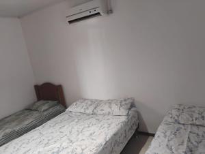 a bedroom with two beds and a radiator and a window at Alugo casa para Argentinos, espaço inteiro in São Gabriel