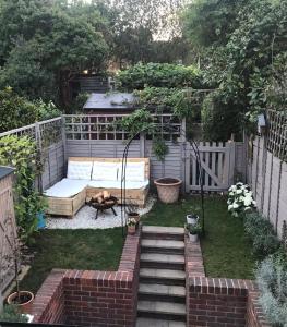 a backyard with a dog laying on the grass at Charming One Bed Cottage in Historic Market Town in Romsey