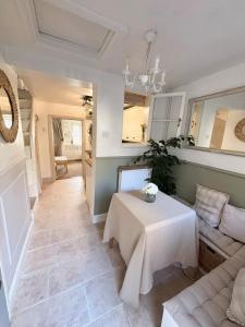 a living room with a couch and a table at Charming One Bed Cottage in Historic Market Town in Romsey