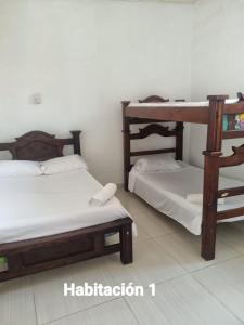 a room with two bunk beds in a room at Kenith ALTO DEL ROSARIO HONDA in Honda