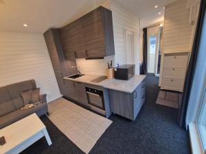 a kitchen with a counter and a couch in a room at River house in Bergsboda +12 photos