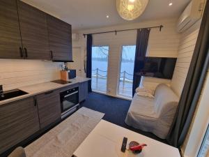 a room with a kitchen and a living room at River house in Bergsboda