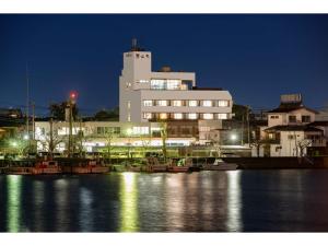 a large building with boats in the water at night at Hotel Shin Makomo - Vacation STAY 32734v in Itako