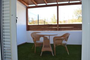 a table and chairs in a room with a window at Villa Mónica by Mirador de Sotavento Apartments in Cardón