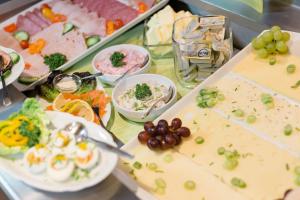 a table with different types of food on it at Friesen Hotel in Jever