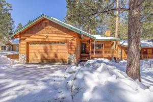 a log cabin in the snow with a garage at TimberWood Cabin- 3 Bdr - 2 Bth - Big Game room - Prime Location in Big Bear Lake in Big Bear Lake