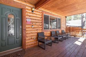 a porch with chairs and a door on a cabin at TimberWood Cabin- 3 Bdr - 2 Bth - Big Game room - Prime Location in Big Bear Lake in Big Bear Lake +58 photos