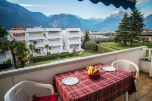a table on a balcony with a view of mountains at Casa Bianca in Riva del Garda