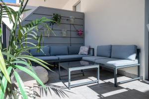a blue couch and a table on a patio at Milanese LODGE/Luxury House in the heart of Milan in Milan