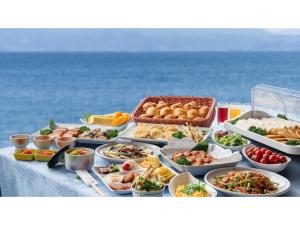 a buffet of food on a table next to the ocean at Ibusuki Kaijo Hotel - Vacation STAY 87383v in Ibusuki