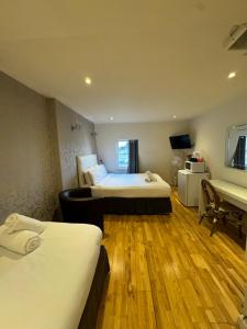 a hotel room with two beds and a piano at The Paramount Hotel in London