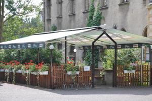 a flower stand with a white canopy and some flowers at Hotel U Kaple in Děčín