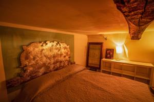 a bedroom with a bed with a head board at Tre Colonne in Terni