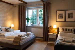 a living room with a bed and a window at Villa la Olive Premium Apartaments-Luxury Standard in Oświęcim