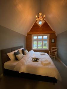 a bedroom with a large bed with a candle on it at Holiday house Vindafjord Norway in Ølsvågen