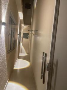 a hallway of a bathroom with a sink and a mirror at Conforto e tranquilidade in Vitória da Conquista