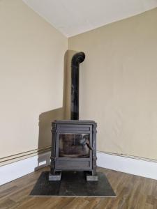 a fireplace in the corner of a room at La ferme 1313 jusqu'à 8 personnes in Cirey-sur-Vezouze