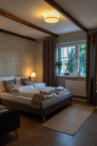 a large bed in a room with a window at Villa la Olive Premium Apartaments-Luxury Standard in Oświęcim