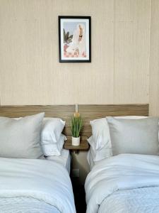 two beds sitting next to each other in a bedroom at Miarlo Lodge Derwent Haven Lakeland in Grange Over Sands