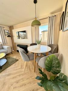 a living room with a table and chairs at Miarlo Lodge Derwent Haven Lakeland in Grange Over Sands