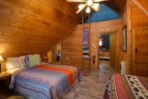 a bedroom with a bed and a ceiling fan at Angel Fire Cabin in Angel Fire