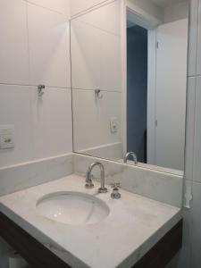 a bathroom with a sink and a mirror at Verano Stay Suite Rio 2 in Rio de Janeiro