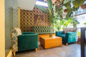 a seating area with two chairs and a table at Ambar Hotel Boutique Cali in Cali