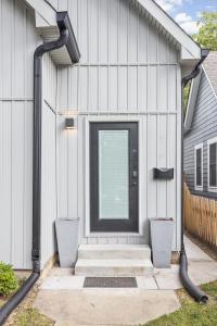 a front door of a house with two trash at Entire Home in Fountain Square in Indianapolis