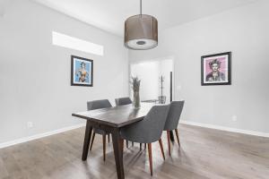 a dining room with a wooden table and chairs at Entire Home in Fountain Square in Indianapolis