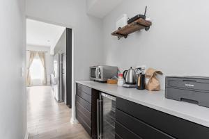 a kitchen with a counter top with a microwave at Entire Home in Fountain Square in Indianapolis +20 photos
