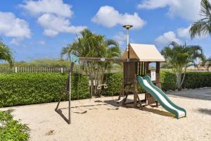 a playground with a slide and a play structure at EagleBeach-Private Pool-Island Delights townhome12 in Palm-Eagle Beach