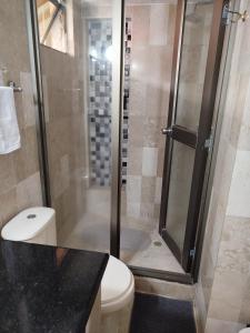 a bathroom with a shower with a toilet and a sink at Casa San Joaquin in Cali +34 photos