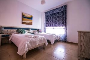 Giường trong phòng chung tại Cotillo Cala II