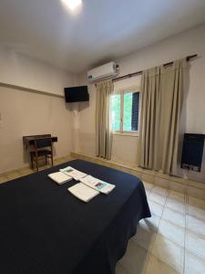 a room with a table with two napkins on it at Hotel Bonino in Villa Mercedes +12 photos